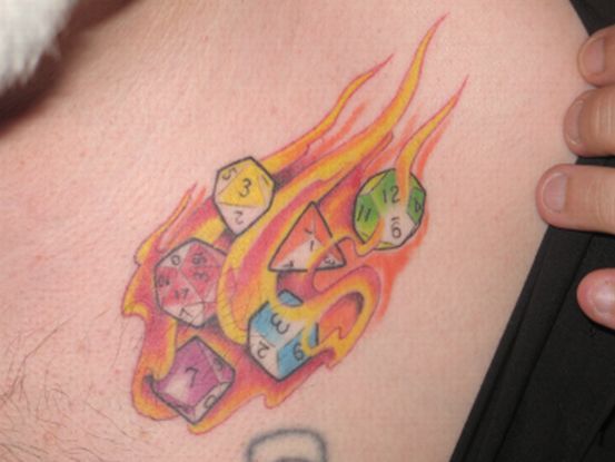 Colorful flaming dice tattoo
