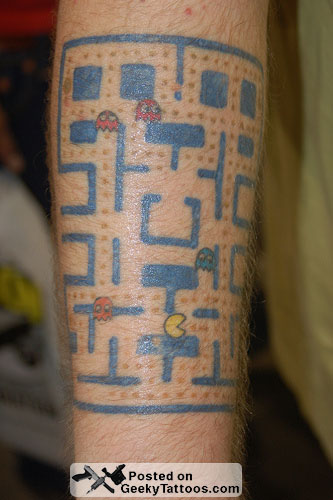 this nicely done small version of the PacMan board on this man's arm
